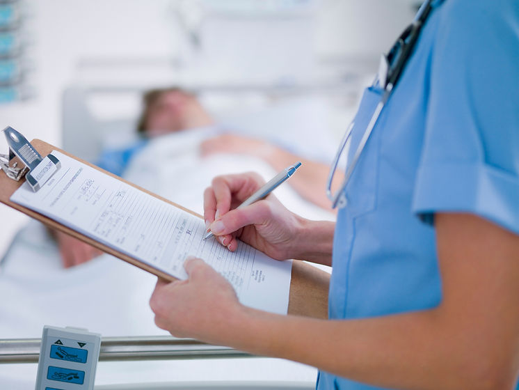 Doctor taking notes during patient consultation